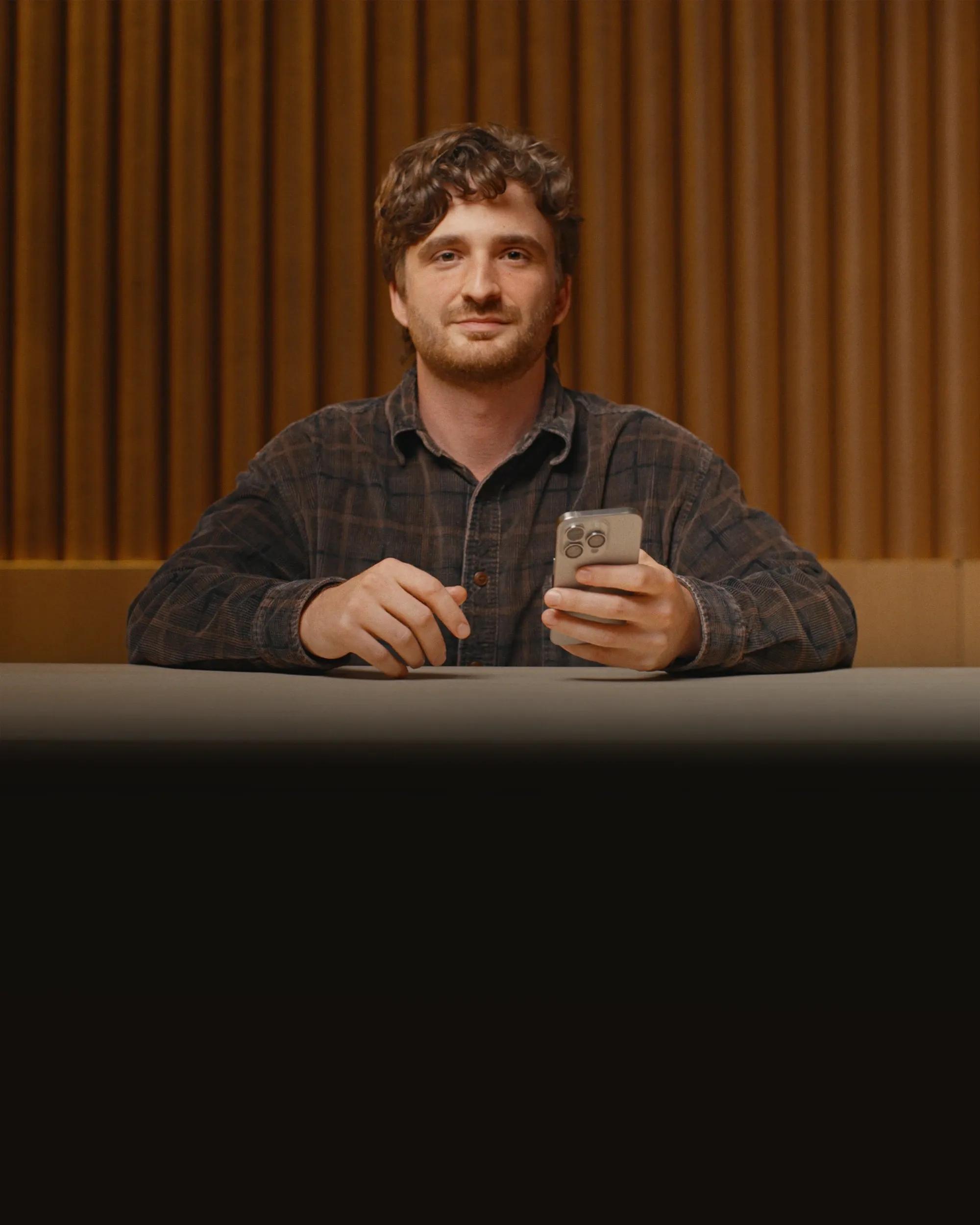 Man sitting down with Iphone in hand
